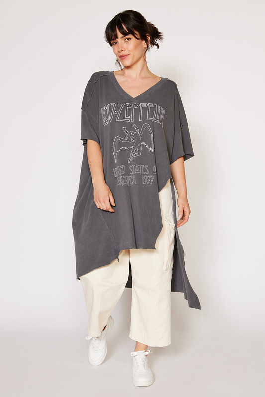 Woman wearing a gray Led Zeppelin tunic with a graphic design on a white background
