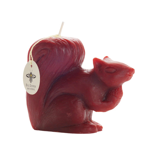 Side view of the red beeswax squirrel candle with Big Dipper Wax Works tag