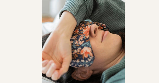 woman lying in eye mask