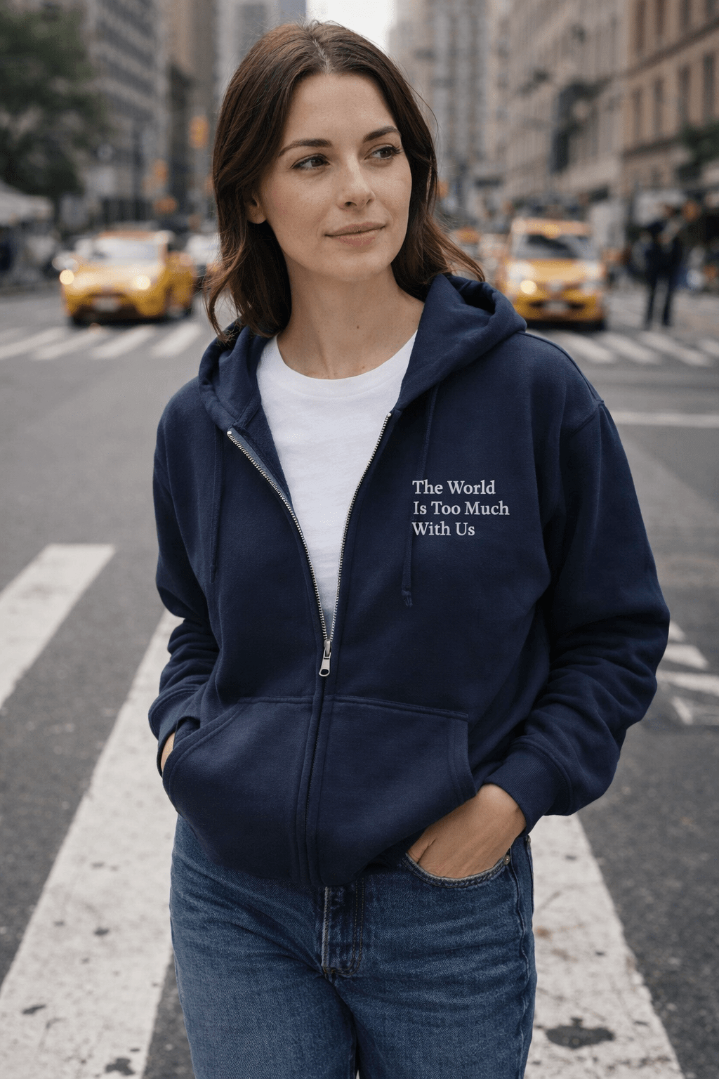 Woman wearing a navy blue hoodie with wordsworth quote on a city street