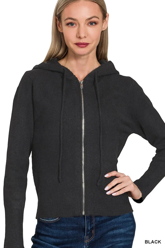 Woman wearing a black zip-up hoodie on a white background