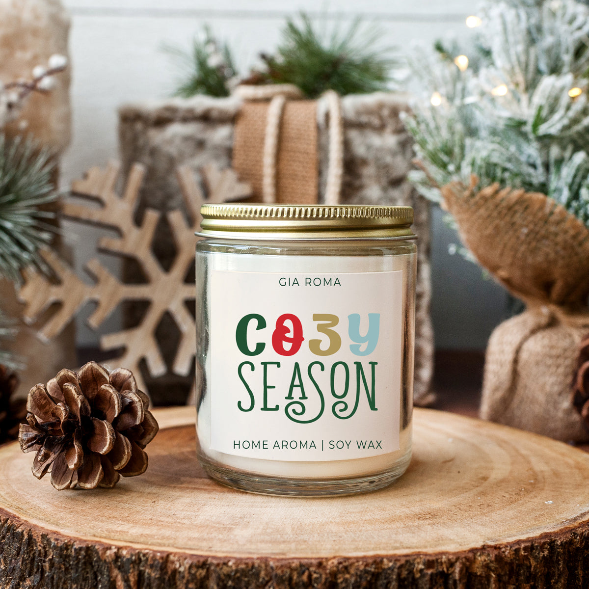 Cozy Season Candle Being Displayed on tree trunk with pine cone