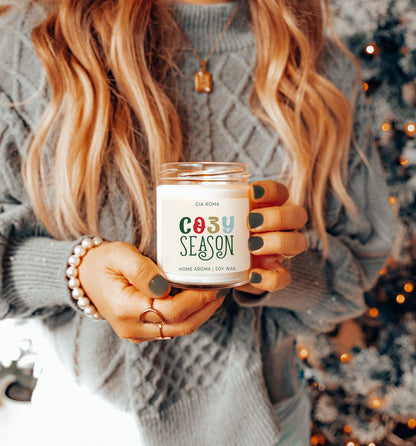 Cozy Season Candle Being Held in a Woman's Hands 