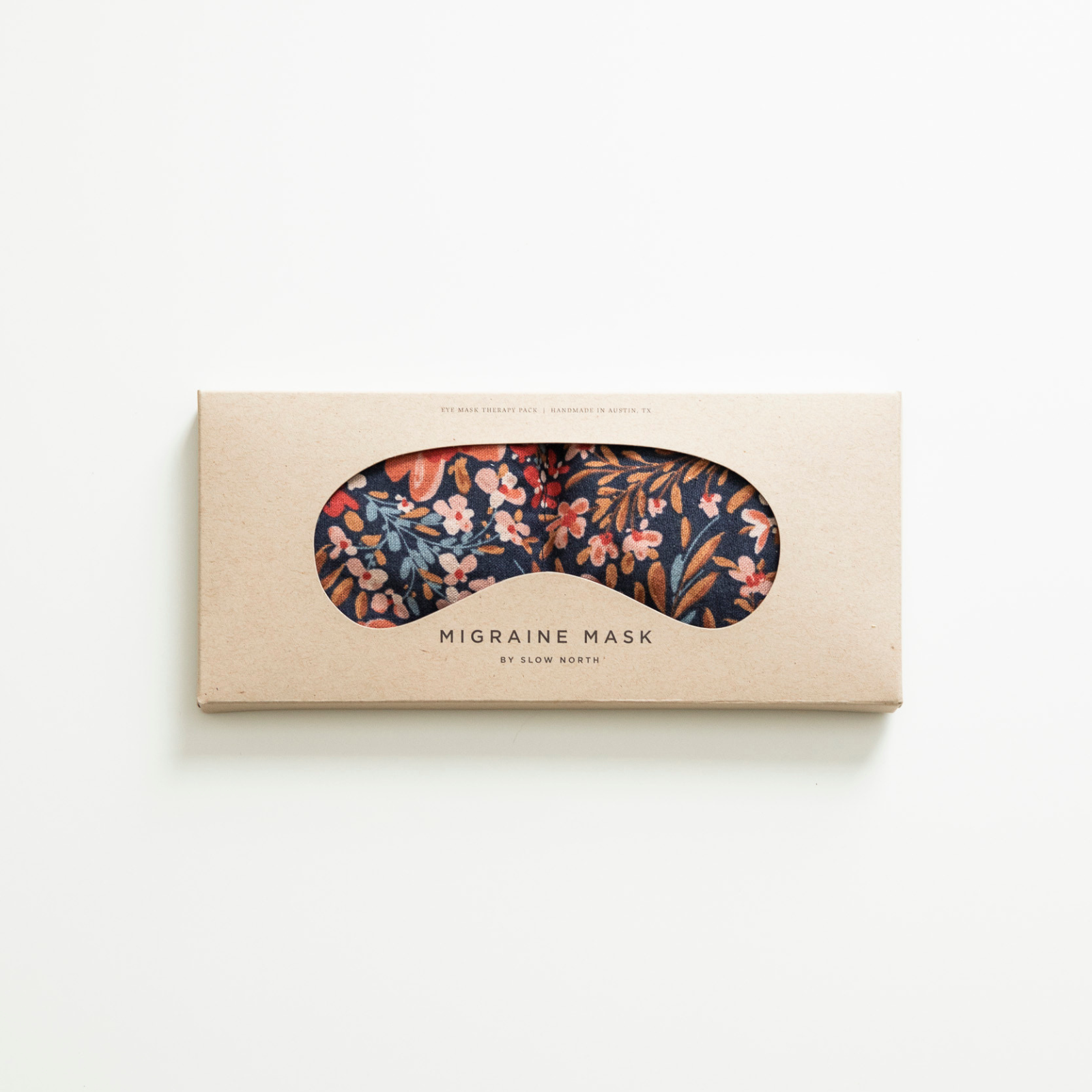 Floral migraine mask in a cardboard box on a white background