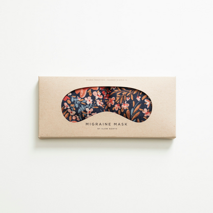Floral migraine mask in a cardboard box on a white background
