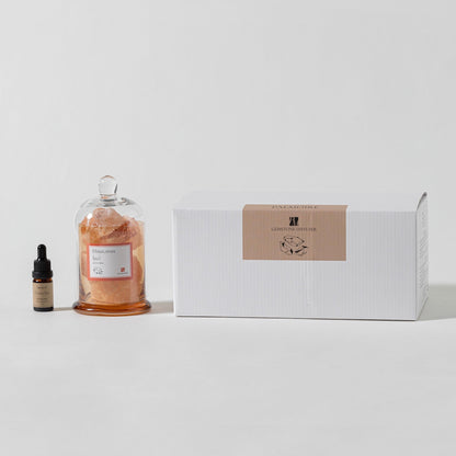 Bottle of skincare product with dropper and box on a white background