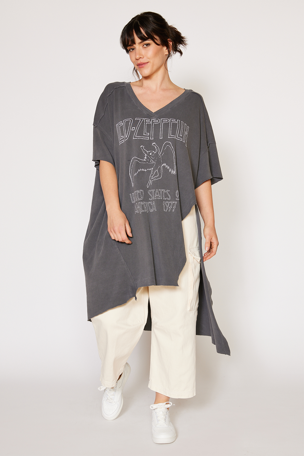 Woman wearing a gray Led Zeppelin tunic with a graphic design on a white background