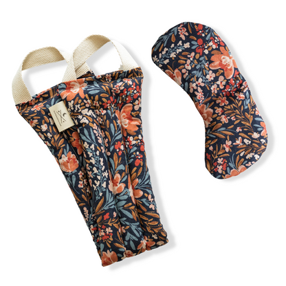 Floral-patterned yoga mat and strap set on a white background