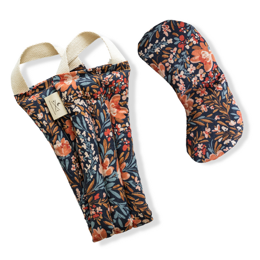Floral-patterned yoga mat and strap set on a white background