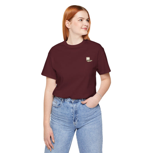 Person wearing a maroon t-shirt with a vintage record logo on a white background