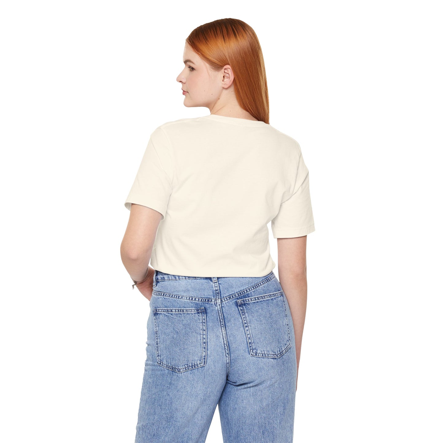 Person wearing a beige t-shirt and blue jeans on a white background