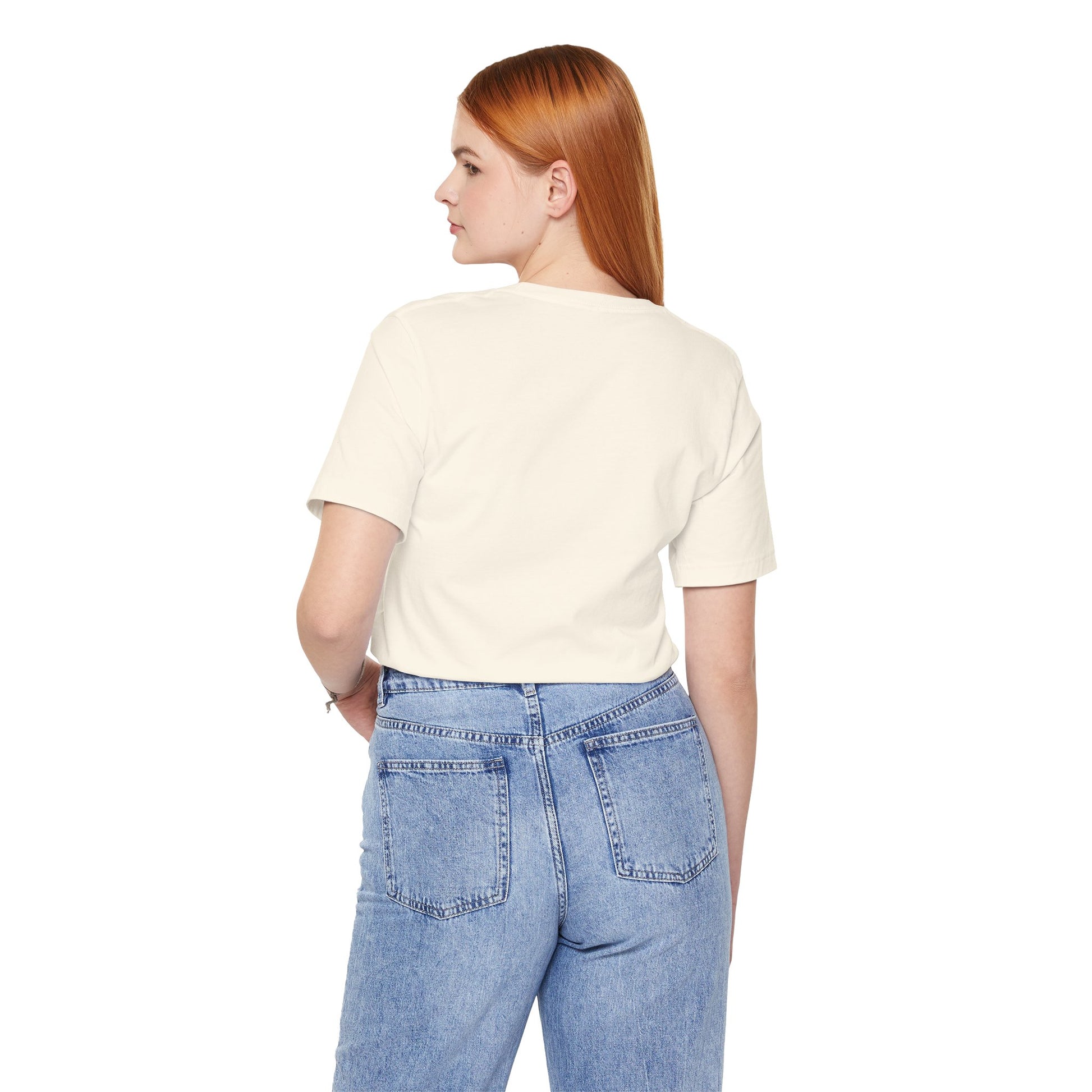 Person wearing a beige t-shirt and blue jeans on a white background