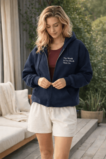 Woman wearing a navy blue hoodie with wordsworth quote outdoors