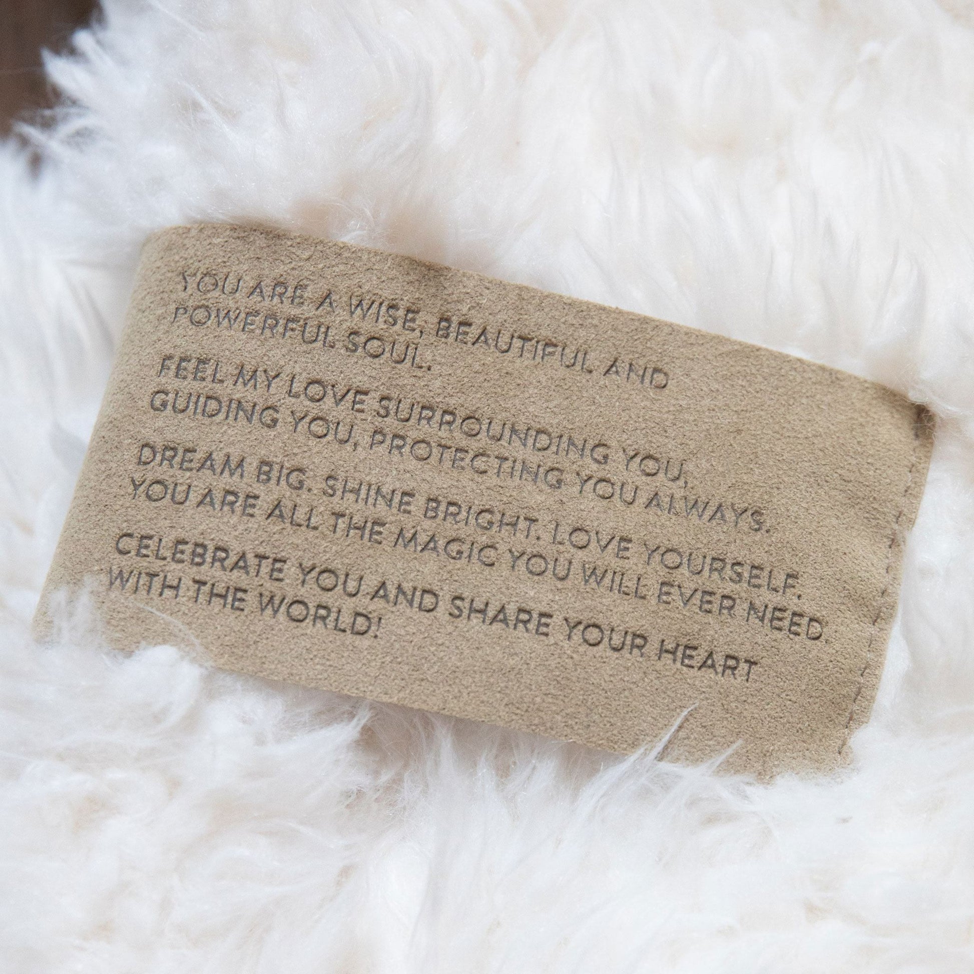 Motivational message card on a fluffy white surface