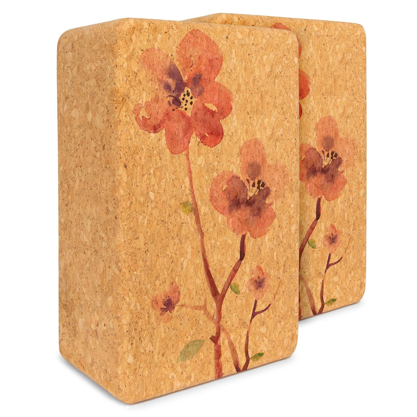 Two cork yoga blocks with floral design on a white background