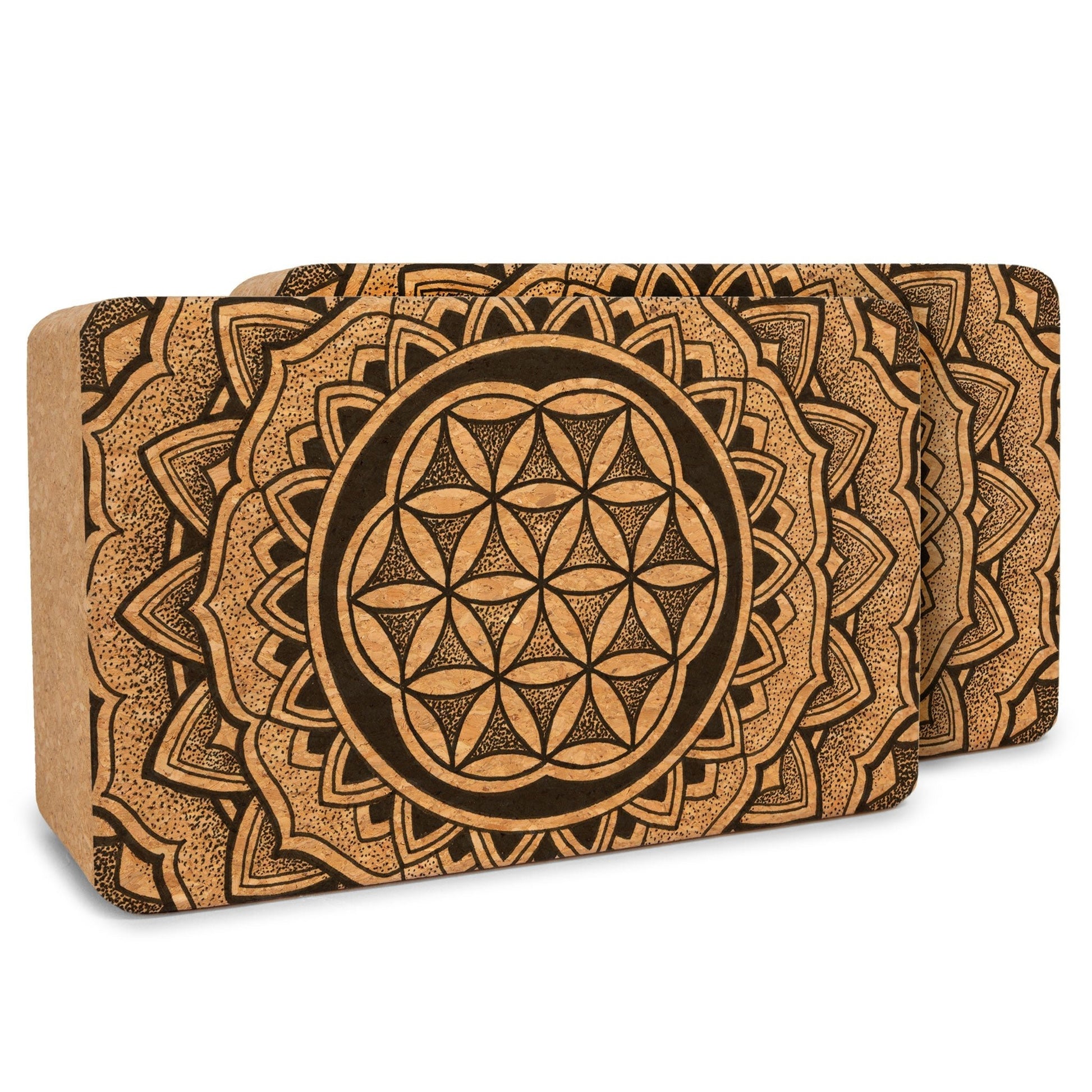 Two cork yoga blocks with mandala design on a white background