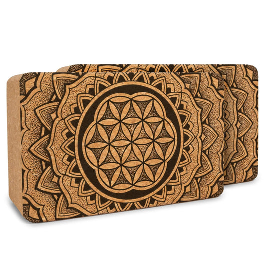 Two cork yoga blocks with mandala design on a white background