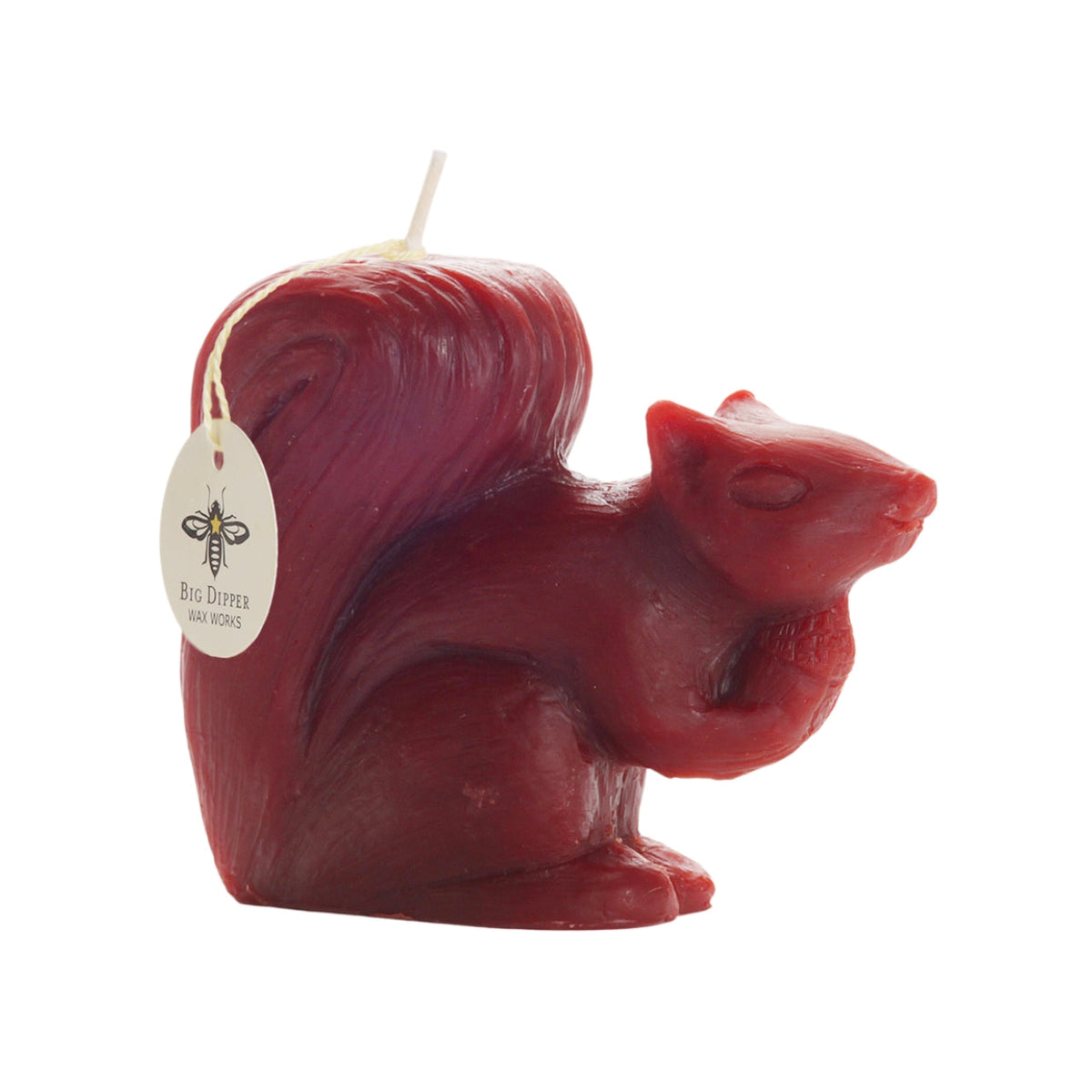 Side view of the red beeswax squirrel candle with Big Dipper Wax Works tag