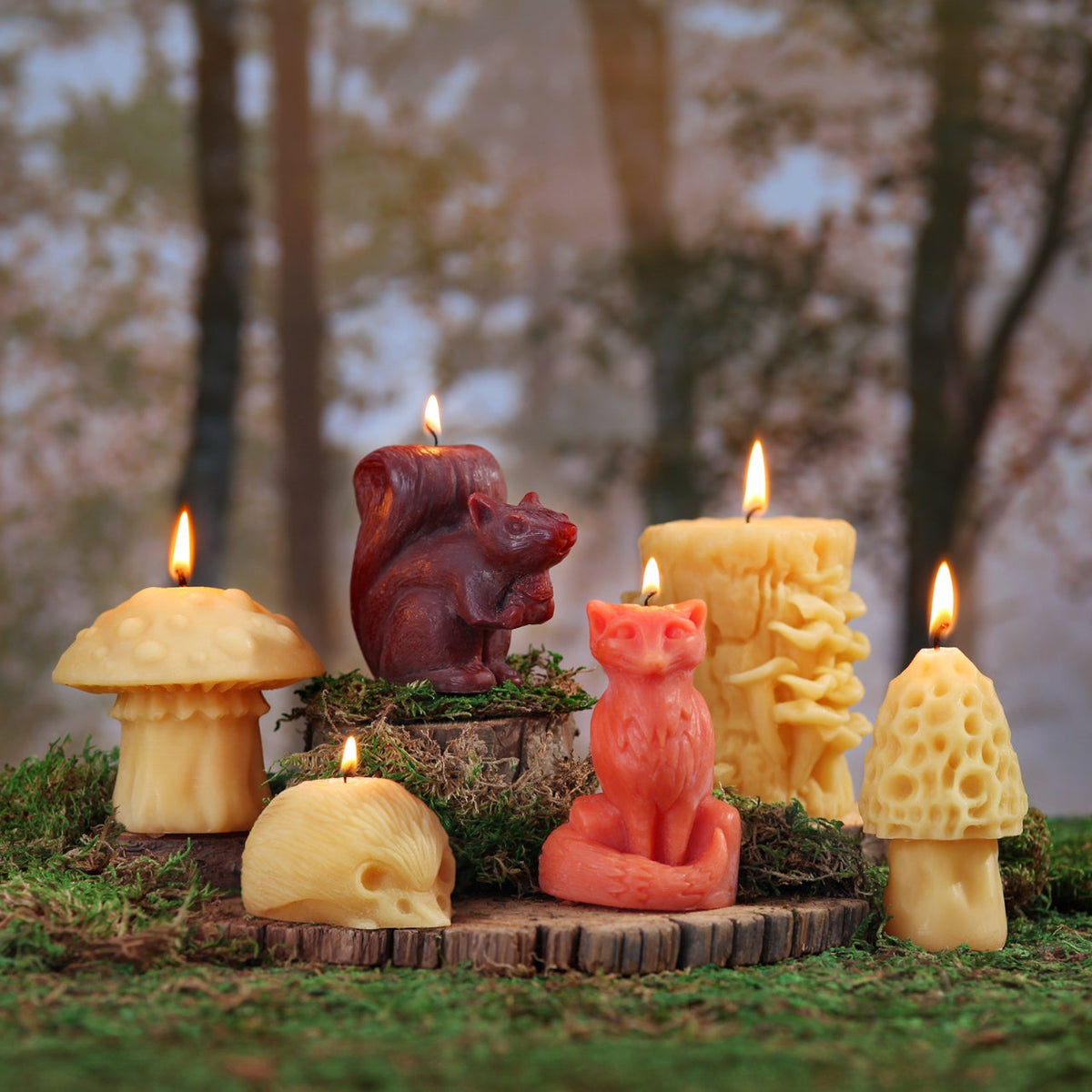 Beeswax squirrel candle among other woodland critter candles on a log in the forest