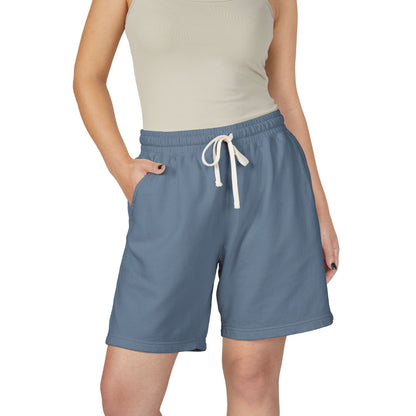 Person wearing blue shorts with a white drawstring on a white background