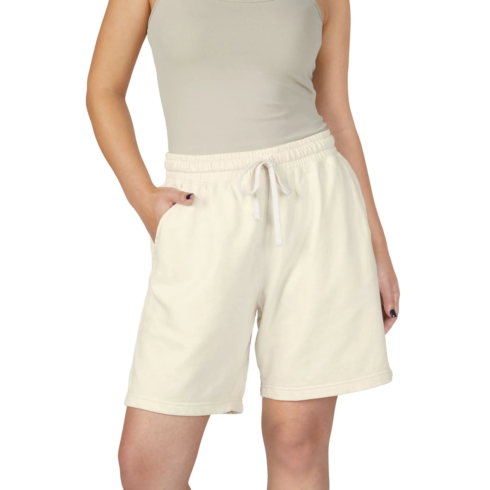 Person wearing ivory boyfriend shorts with a white drawstring on a white background