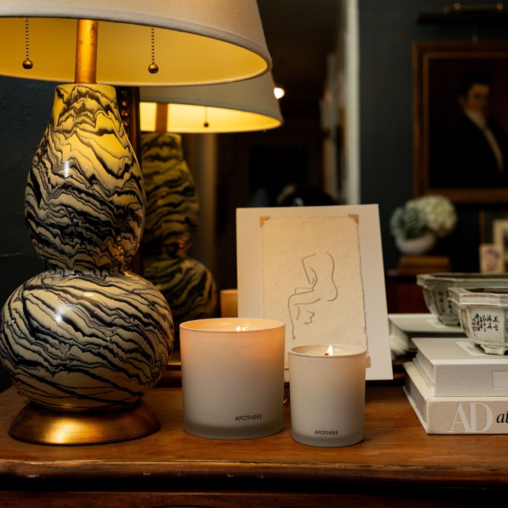 Decorative lamp and candles on a wooden surface with a blurred background