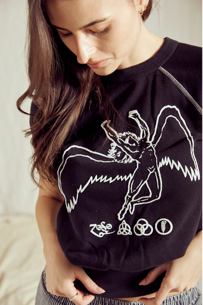Woman wearing the black Led Zeppelin Icarus raglan tee, showing the Icarus artwork on the front