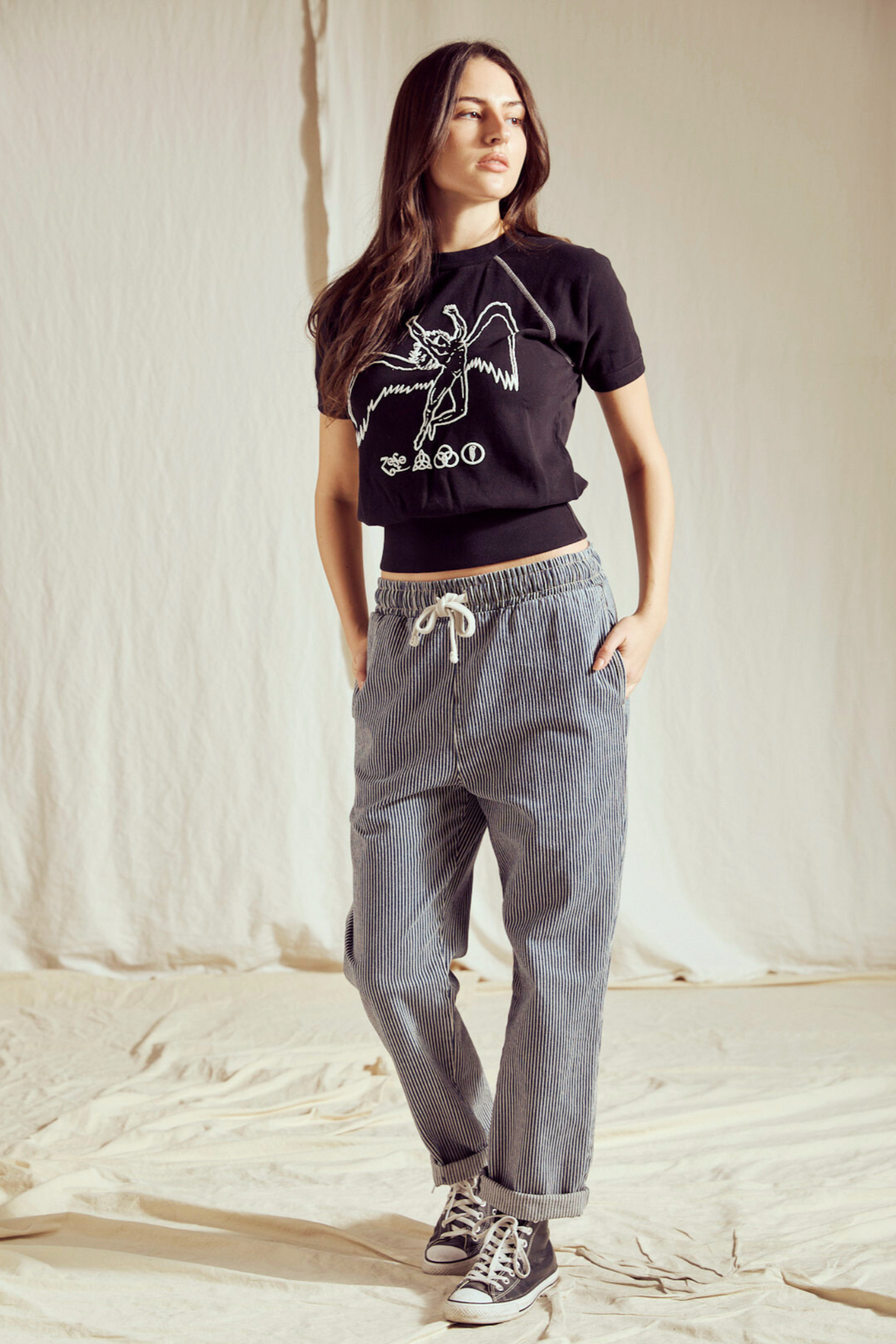 Full-length view of the black Led Zeppelin Icarus raglan tee worn with relaxed jeans