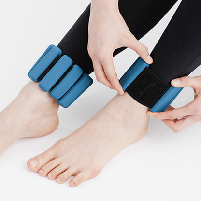 Woman fastening blue silicone weight bangle around ankle showing adjustable Velcro strap
