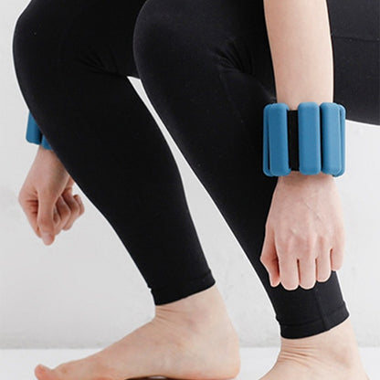 Woman wearing blue silicone wrist weights.